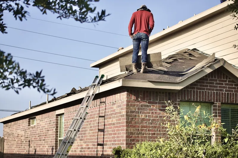 Professional roofer working on a residential roof in Lauraville
